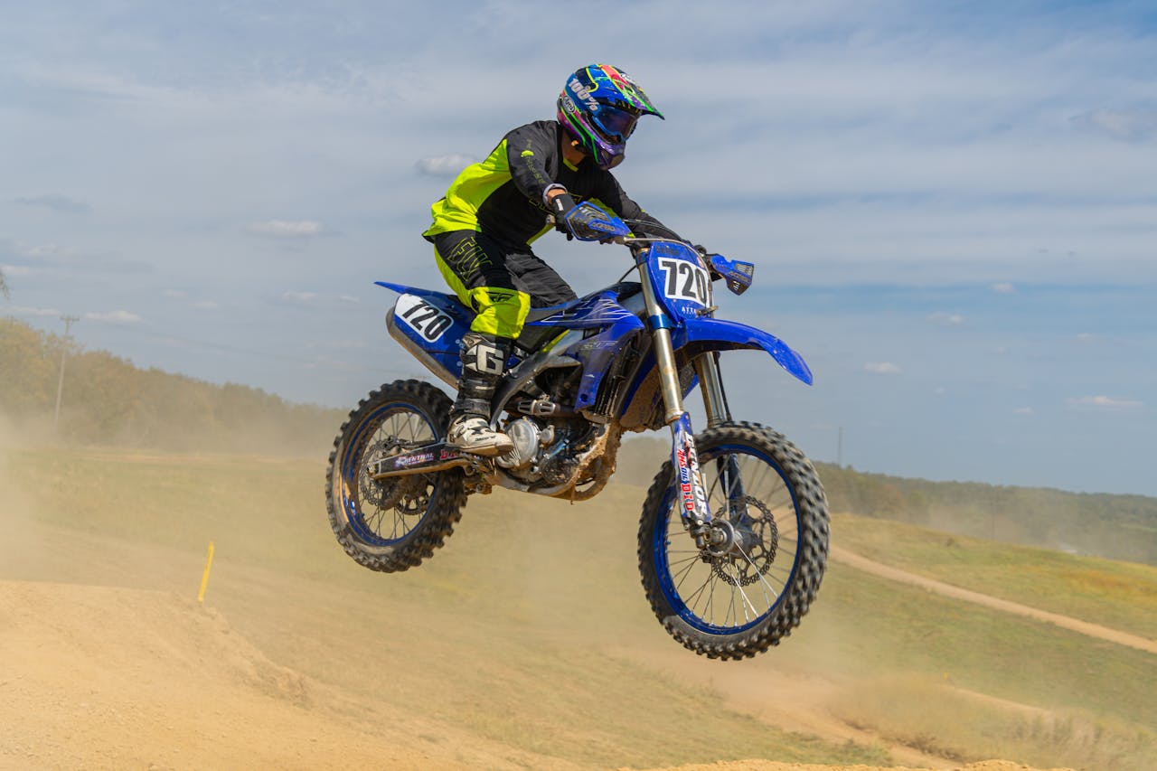 about-img-04 motocross-rider-jumping-mid-air-on-dirt-track-33896135